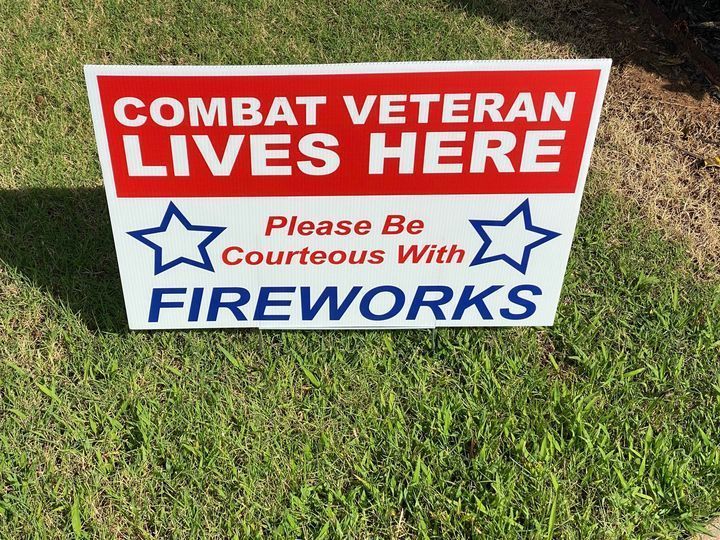 A photo of a yard sign identifying a Combat Veteran Lives Here