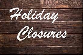A photo with wood background that reads Holiday Closures